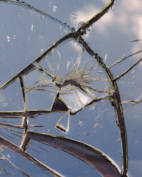 the broken windshield of a vehicle that has been badly damaged