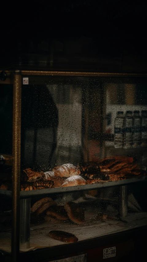 a food display in the dark with water on it