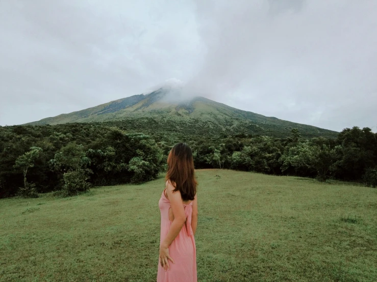 a woman looking up at a large hill