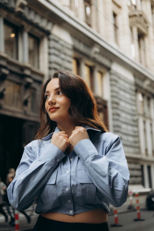 a woman posing for a picture in a blue shirt