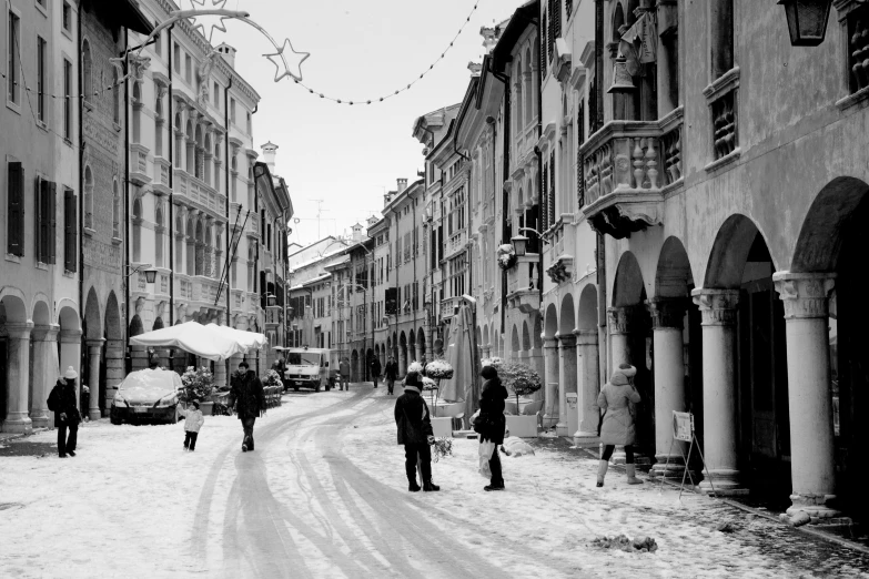 people walking on a snowy street in a city