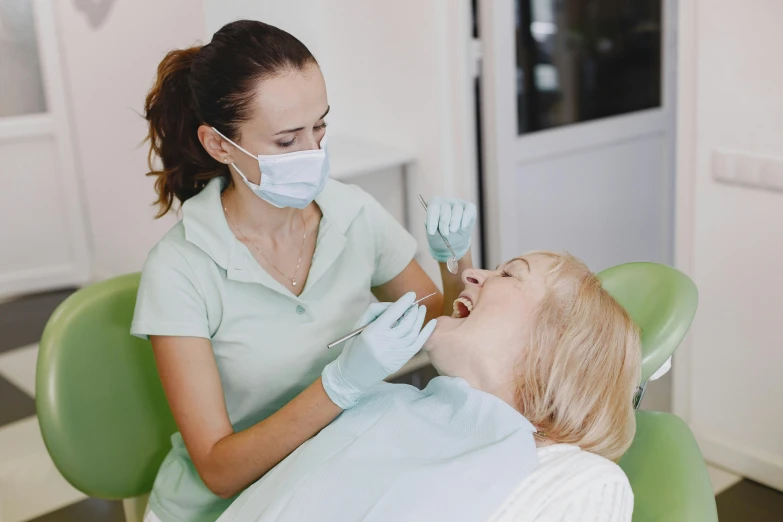 a woman getting her teeth brushed with surgical equipment