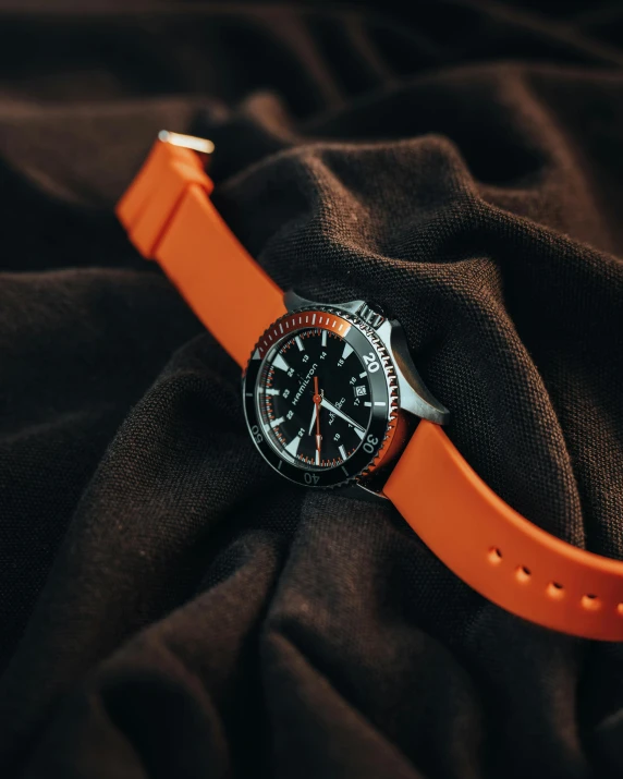 a watch on top of a black cloth