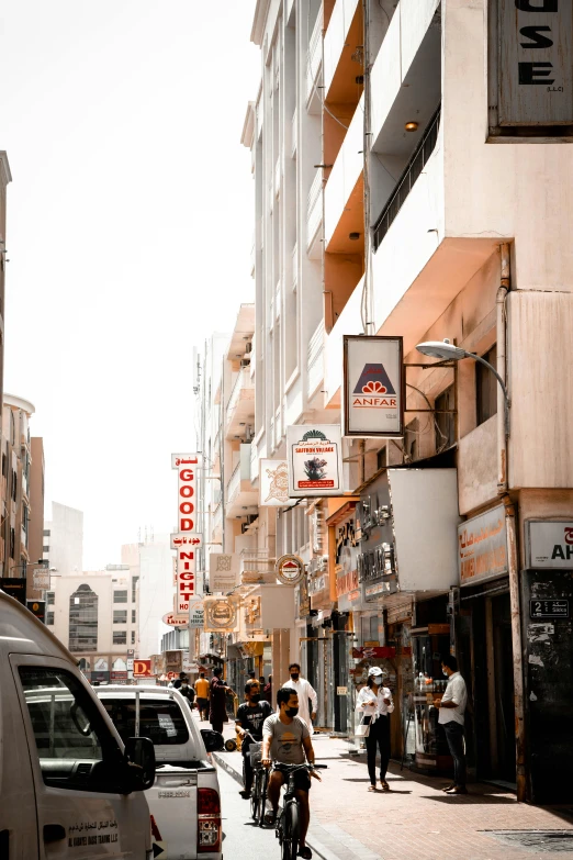 cars and motorcycles are parked near buildings and tall buildings