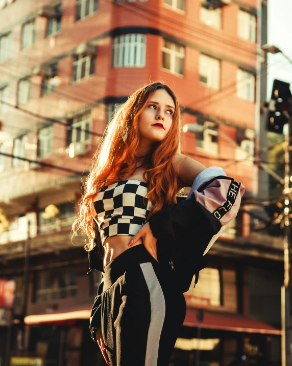 a woman stands on the side of a road