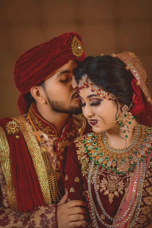 a young couple dressed in elaborately decorated clothes