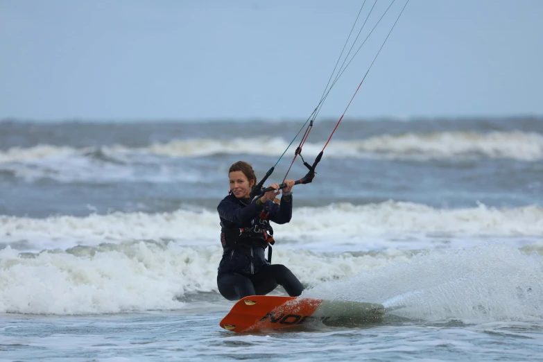 a woman that is hanging onto some kind of rope