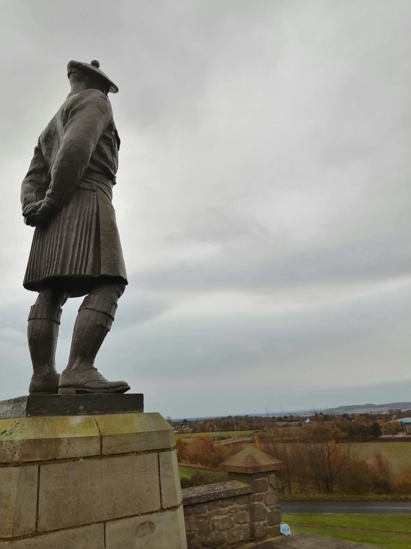 a large statue that is next to a wall