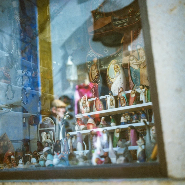 a window display with a bunch of dolls