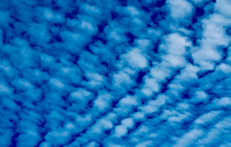 an airplane in the sky is flying through the clouds