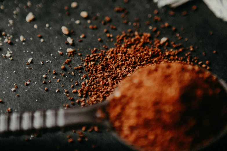 red stuff in the spoon and on the black table