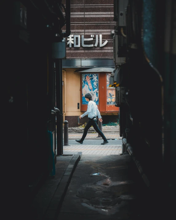 a person walking down a sidewalk in a city