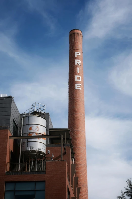 an industrial building with a large smoke stack
