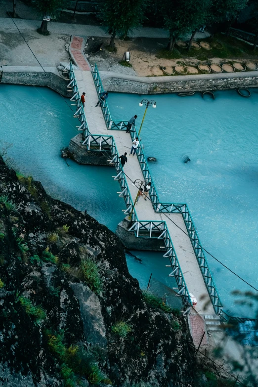 a pier and walkway over the blue water