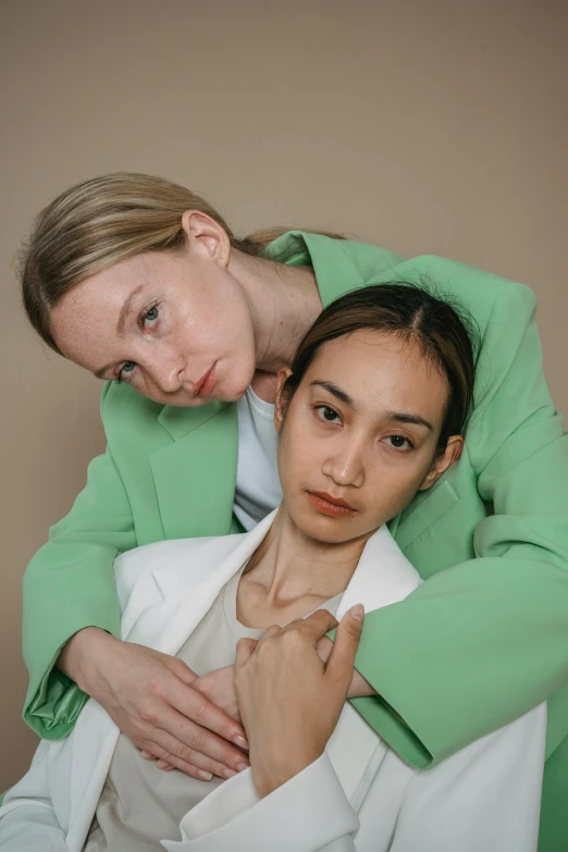 a woman that is holding her arm around another woman