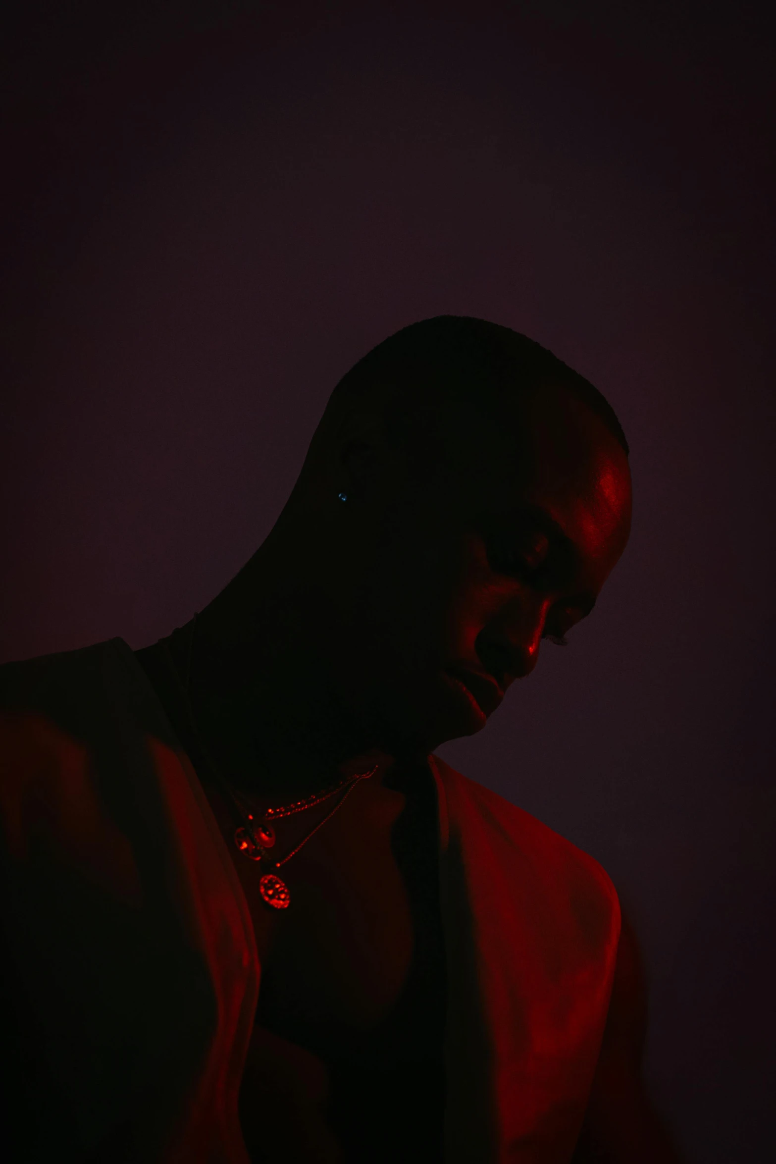 a man standing in the dark with a red light coming out of his eyes