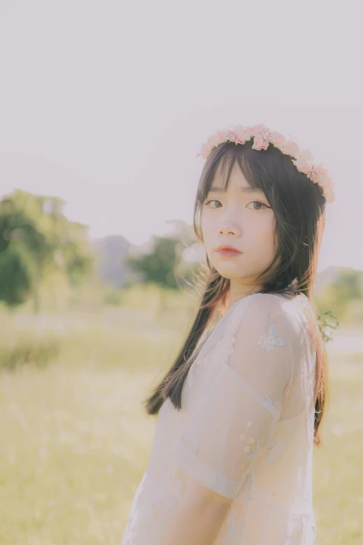 young asian woman in a white dress posing for the camera