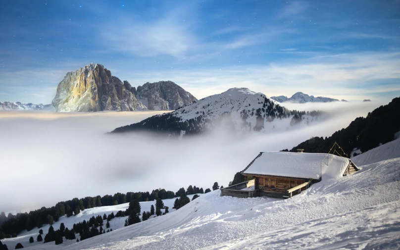 a house nestled on a mountain above the clouds