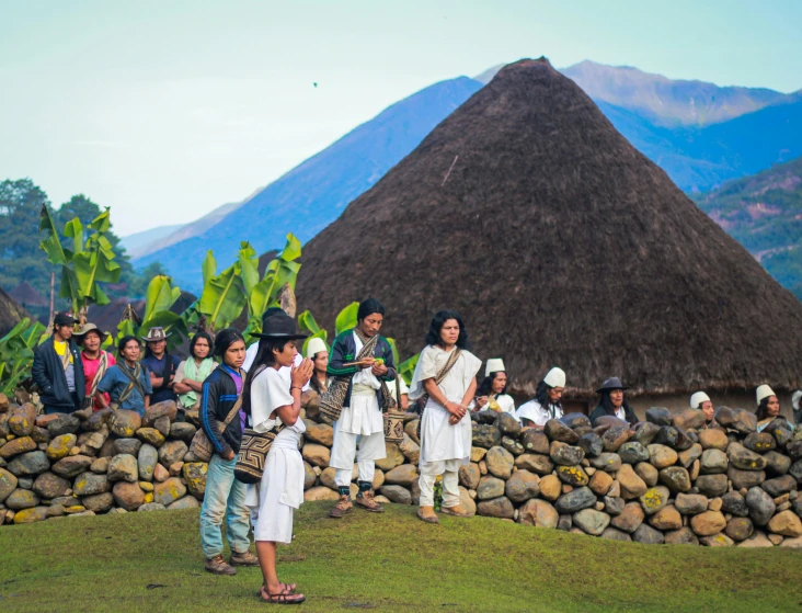 a group of people are standing outside by a wall