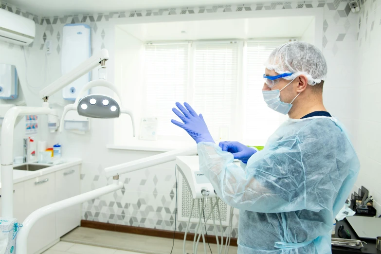 a man in a lab with a blue glove on