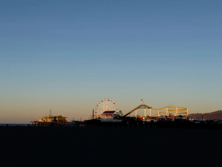 an amut park at twilight with the roller coaster