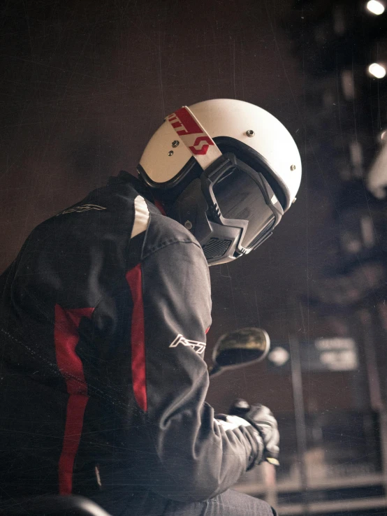 a man wearing a helmet and sitting on a motorcycle