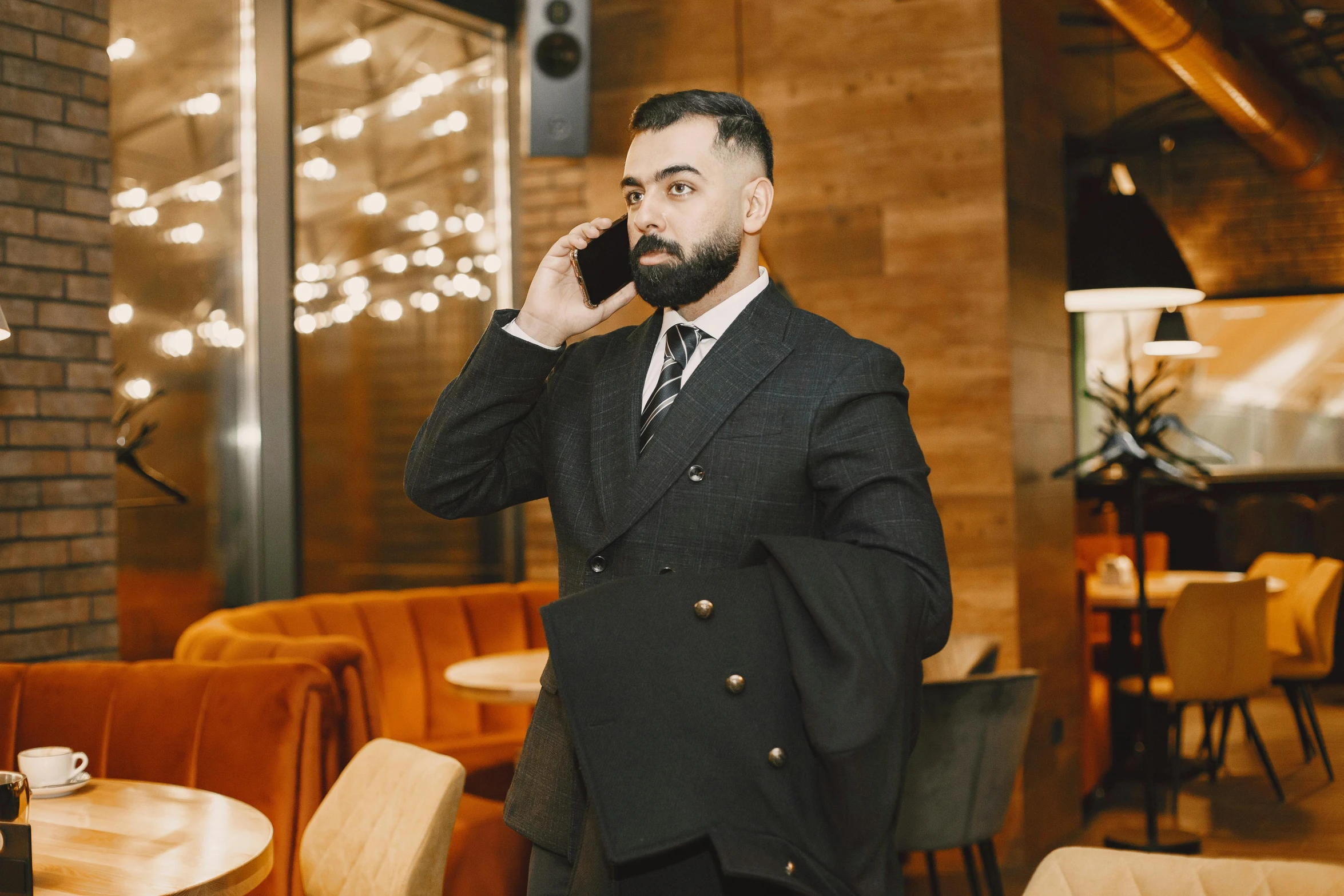 a man wearing a suit while on a cellphone