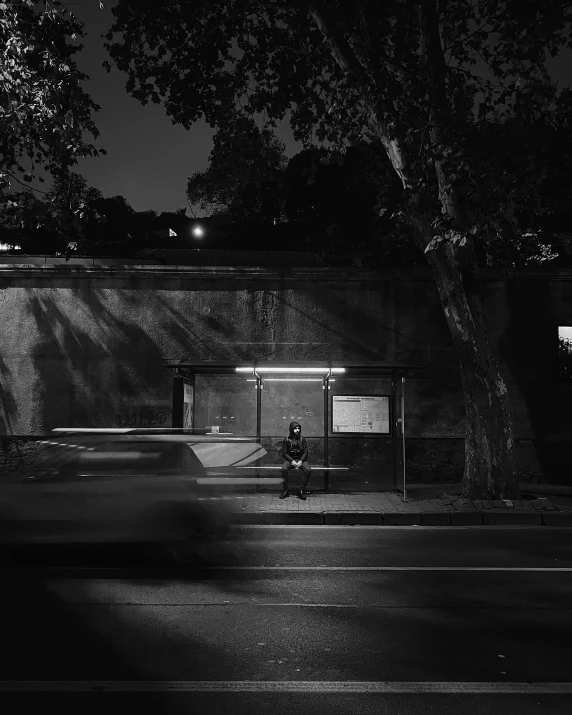 a city at night that has an empty bench