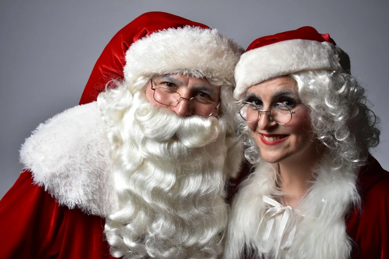 a couple of people in christmas outfits posing for the camera