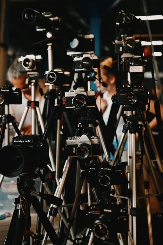 a group of cameras sitting on top of a wooden table