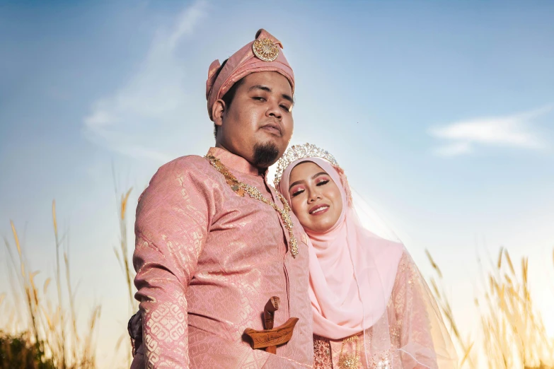 a young man and woman in pink are posing for a po