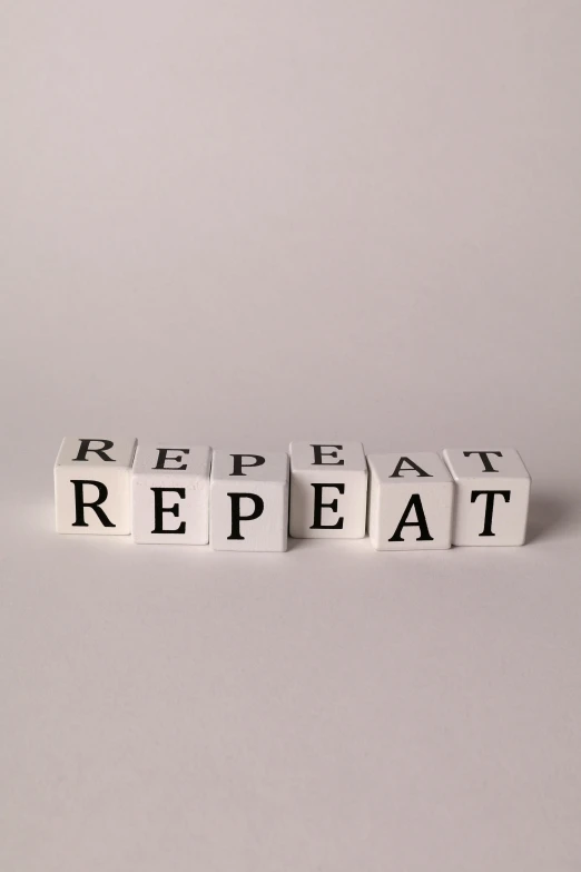 word written in scrabbled white letter blocks with words repeated