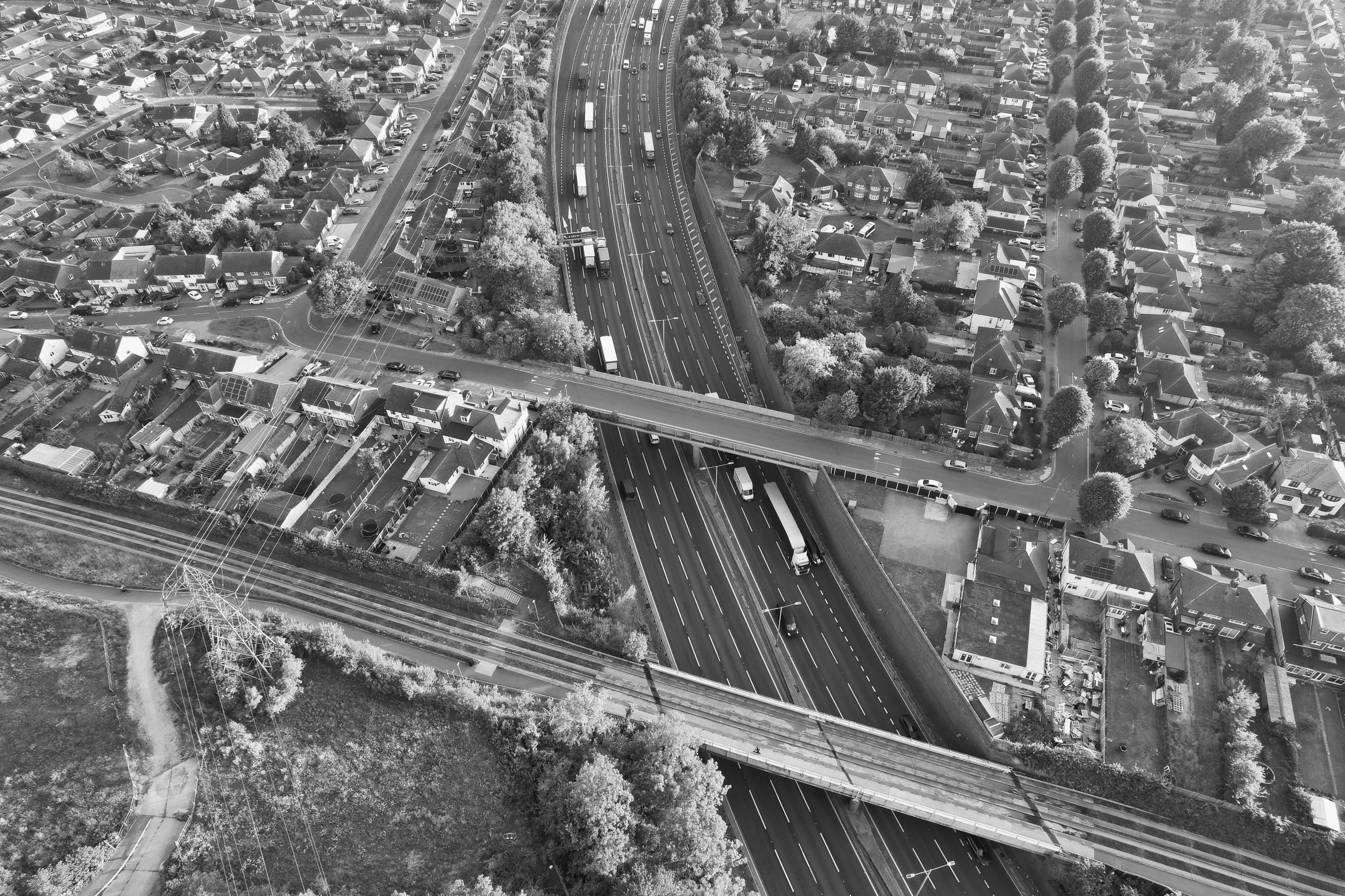 an aerial view of freeway with cars driving down it