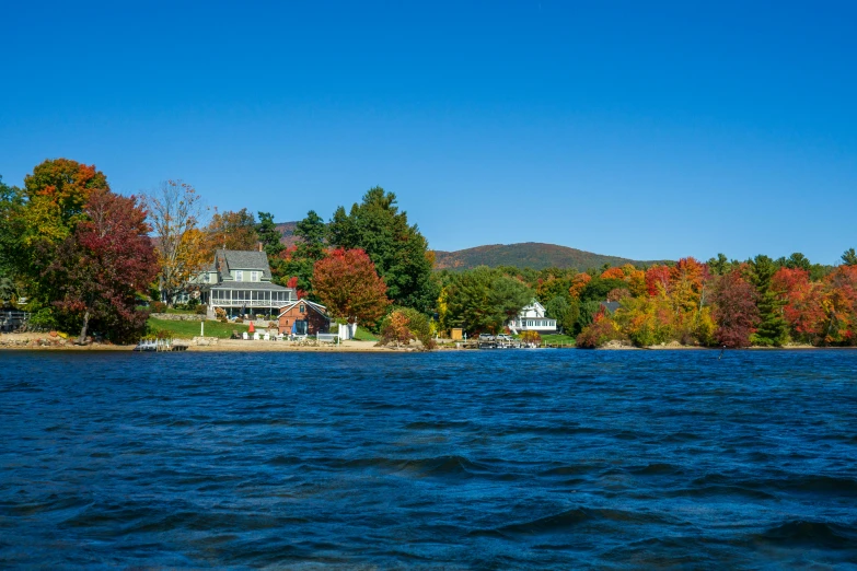 a large lake that has a house and a bunch of trees