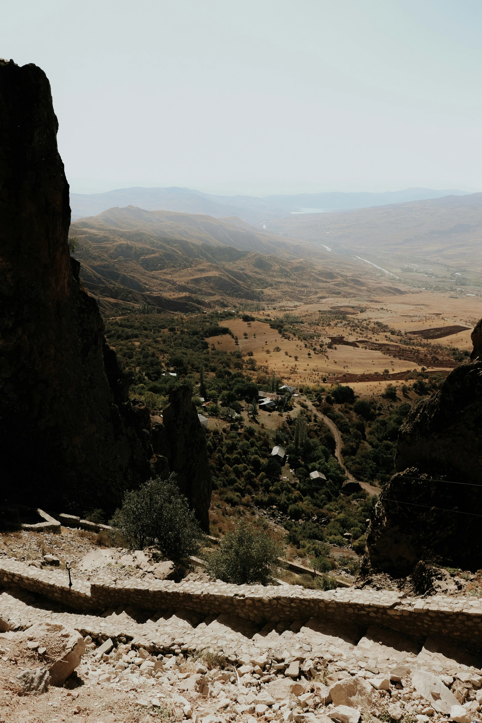 a man sitting on top of a rocky cliff