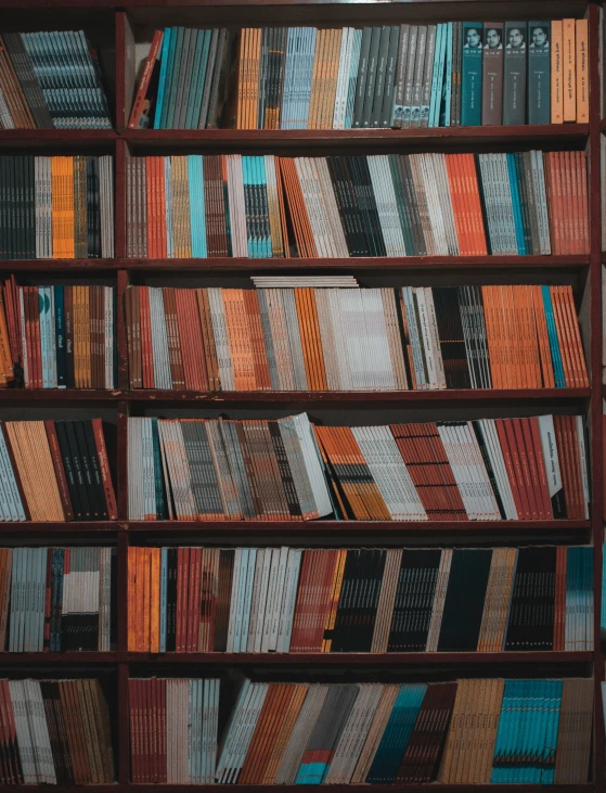 stacks of books on a shelf with different patterns