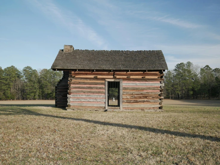 a log cabin sitting on top of a field