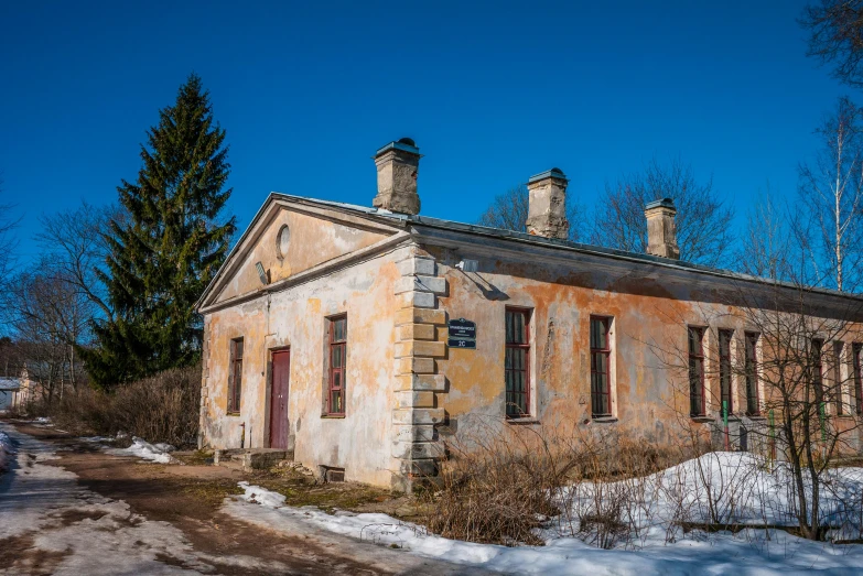 a house sitting in the middle of winter time