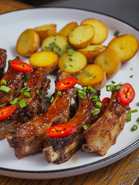 a plate with meat and potatoes on top of it