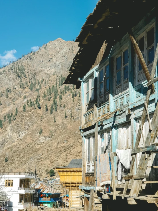 a blue building sitting in the middle of a town