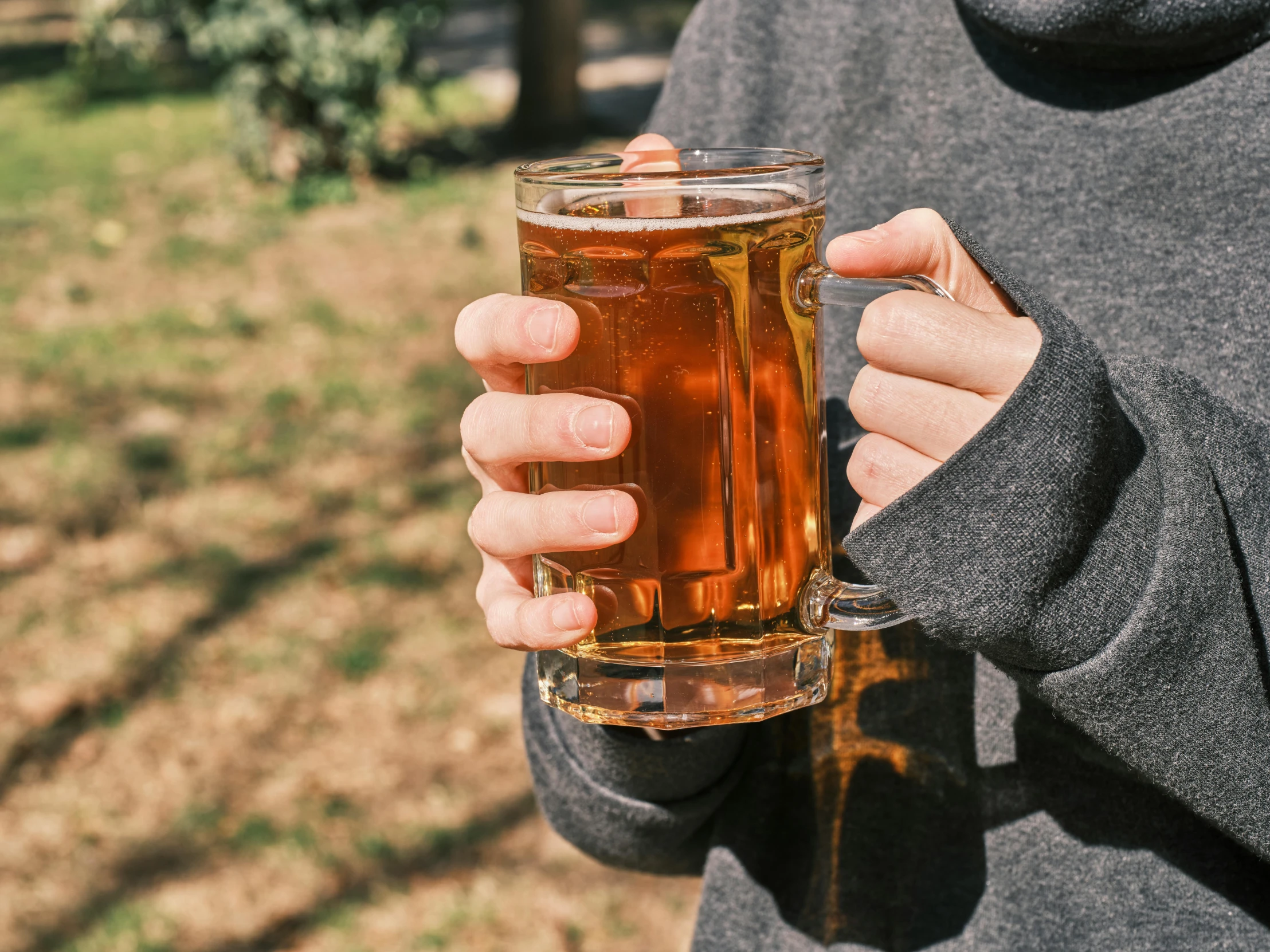 a man holding a beer in a glass