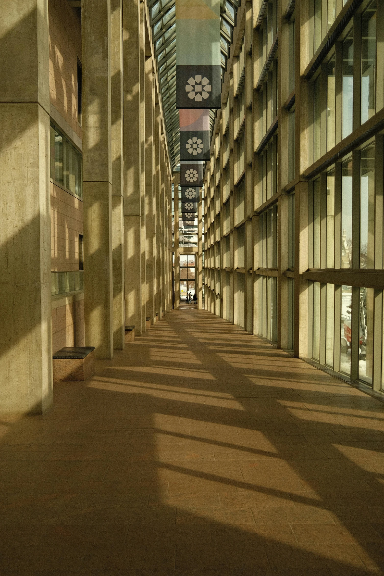 an empty hallway with many windows and windows with a clock