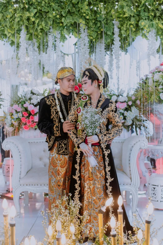 a couple is wearing traditional wedding clothes