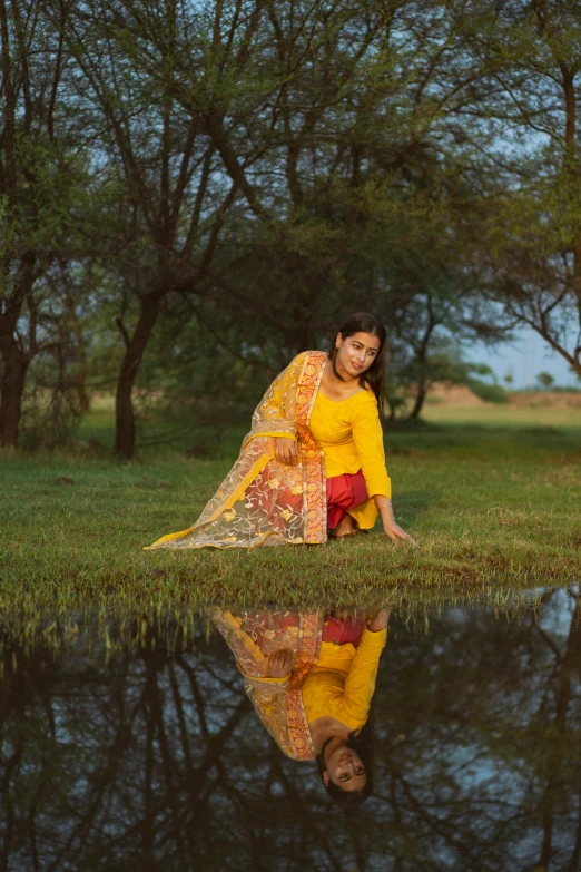 the girl in the yellow dress is looking at her reflection