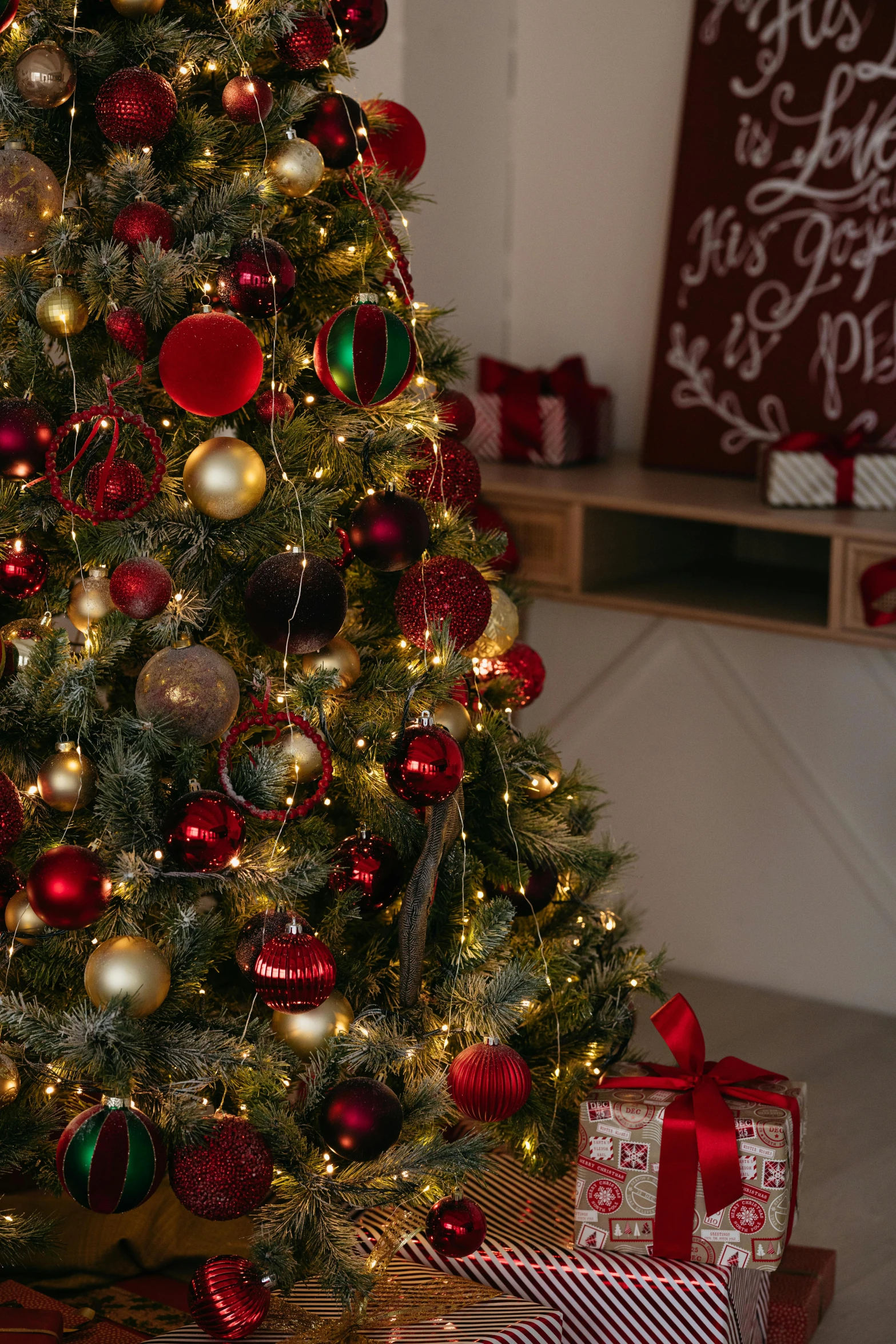 a christmas tree with many presents in front of it