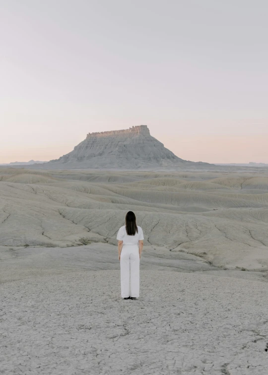 a woman stands in the middle of nowhere