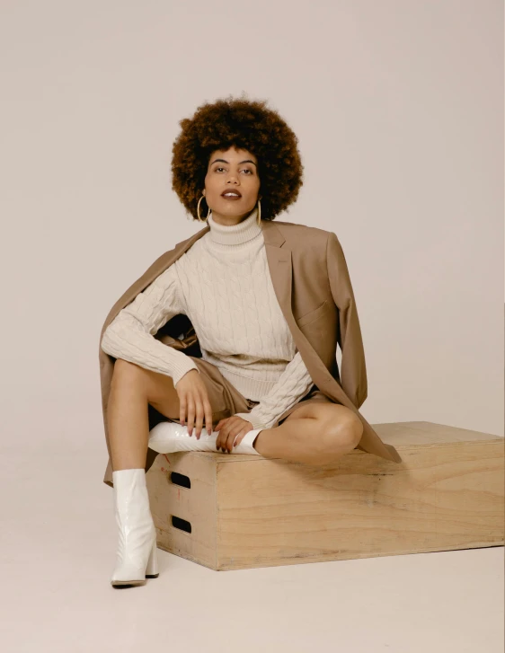 a black woman sitting on a stool wearing white socks