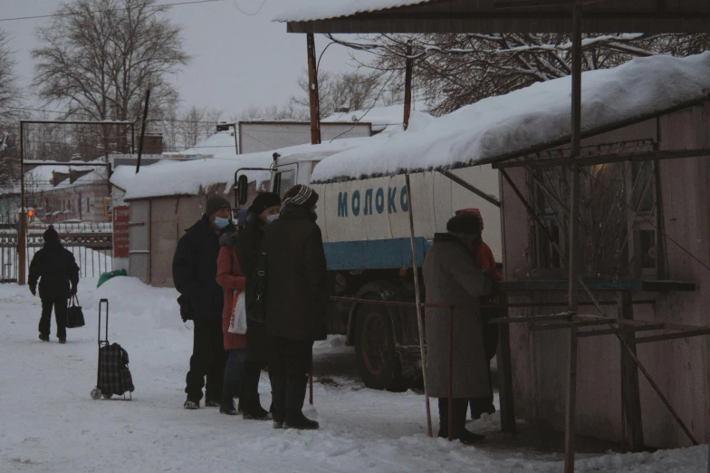 people standing outside a building with a truck on it