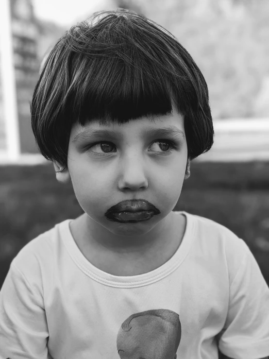 black and white po of a little boy with his tongue out