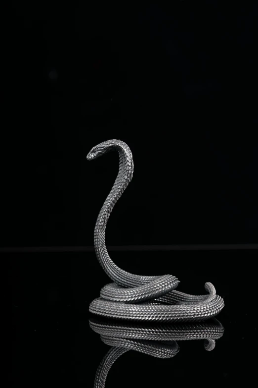 a snake sculpture is shown on a table